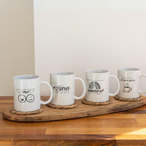 Inspirational coffee cups arranged on a kitchen counter
