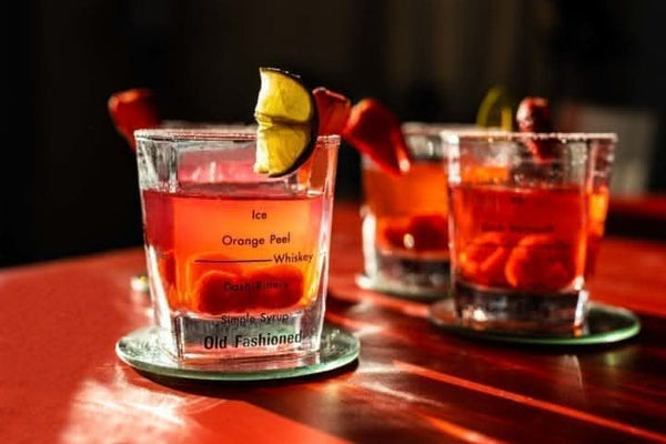 Four cocktail glasses with measurement guides