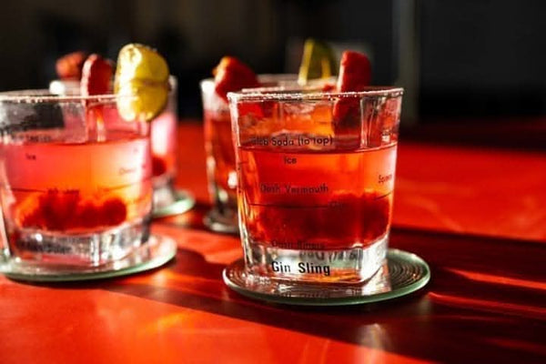 Cocktail glasses with recipes printed on sides