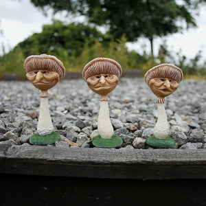Miniature mushroom decorations shown together outdoors