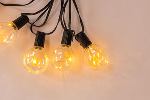 Mains powered outdoor string lights on patio
