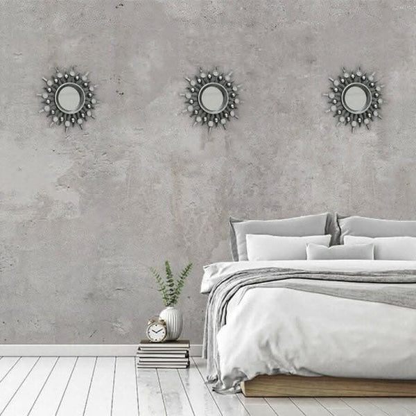Round silver mirror surrounded by smaller mirrored details