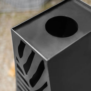 Black metal trash can with geometric design on a blurred background