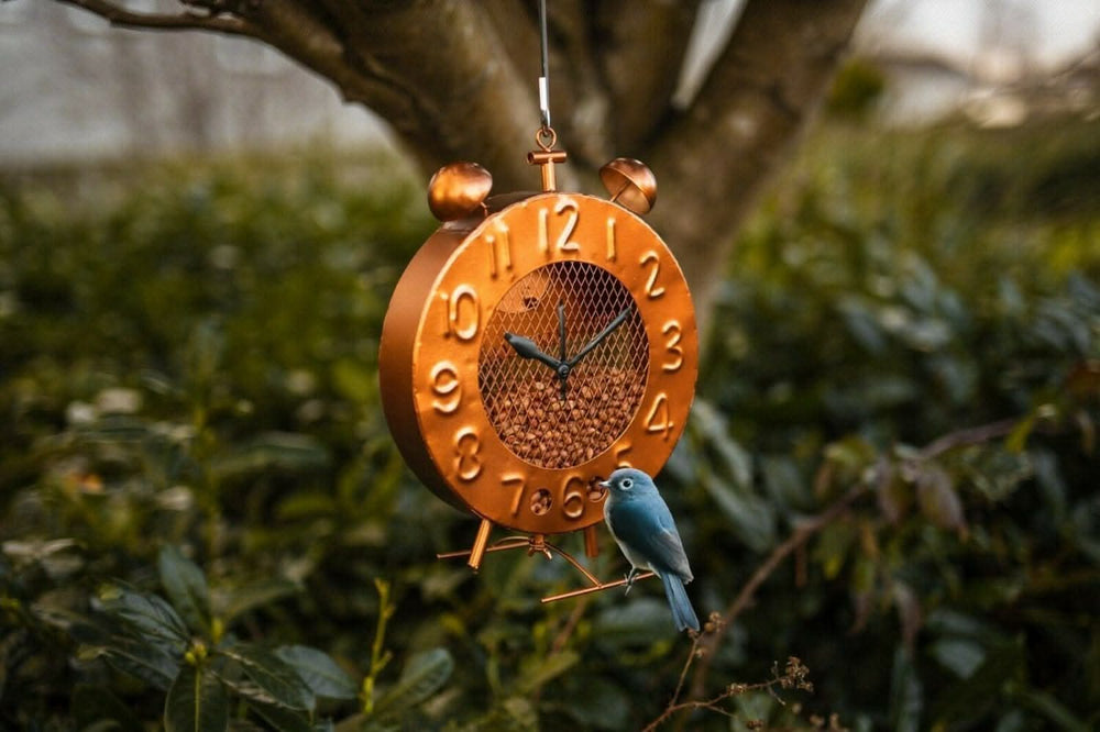 Copper clock bird feeder with vintage garden design