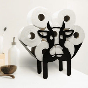 Cow shaped holder filled with toilet rolls