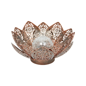 Decorative metal solar garden lantern illuminated at night