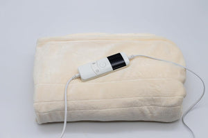 Cream electric throw blanket displayed on sofa