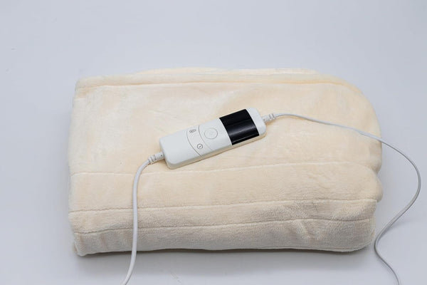 Cream electric throw blanket displayed on sofa