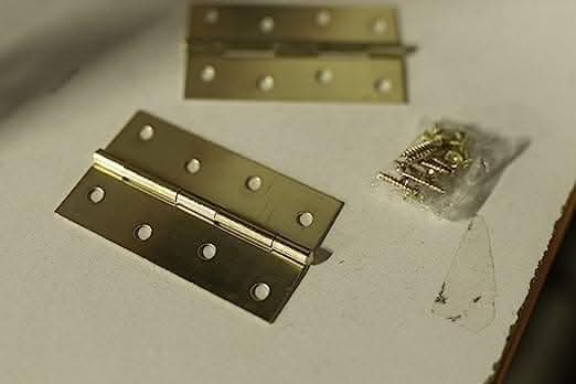 Folding door hinges with attractive brass plated surface