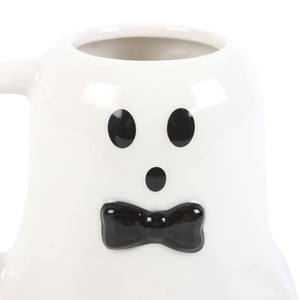 White mug with ghost face design featuring black eyes and bow tie on a white background