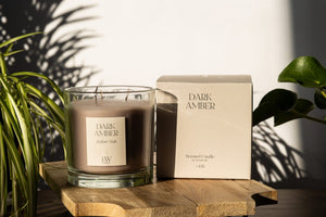 Dark Amber scented candle displayed in a living room