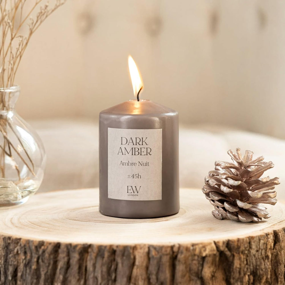 Dark amber scented soy wax pillar candle.
