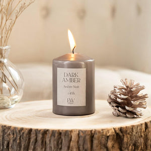 Dark amber scented soy wax pillar candle.