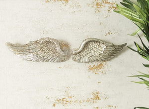 Small decorative angel wings with detailed feather design