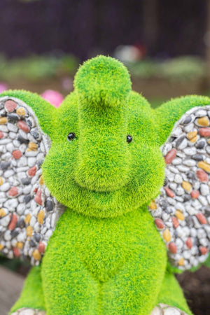 Stone effect elephant ornament beside garden plants