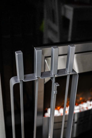 Four piece fireside tools displayed on stand