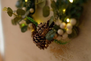 White LED lights glowing among artificial sage foliage