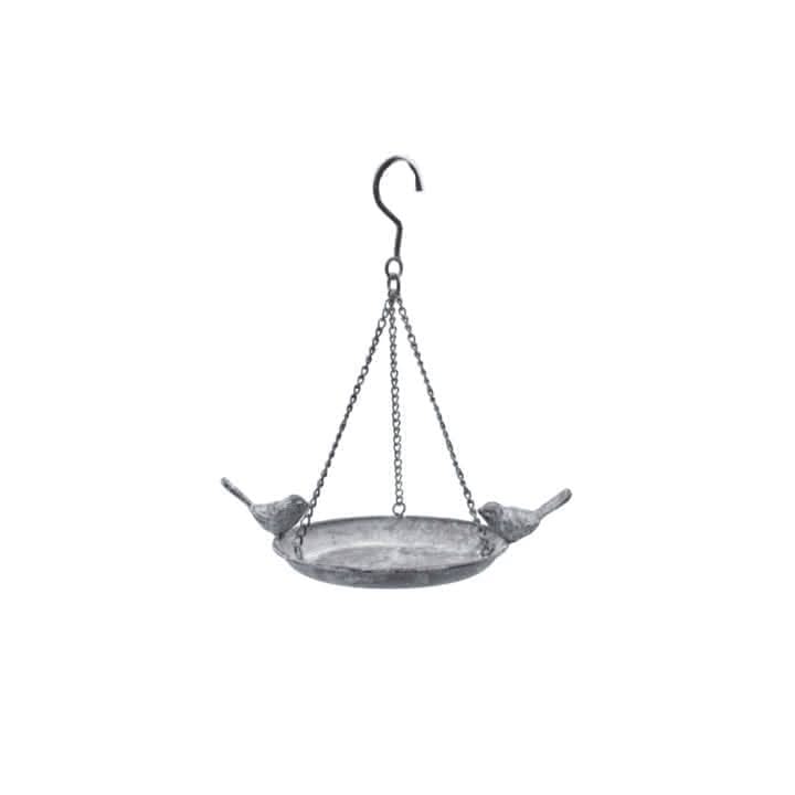 Hanging metal bird bath and seed feeder in garden