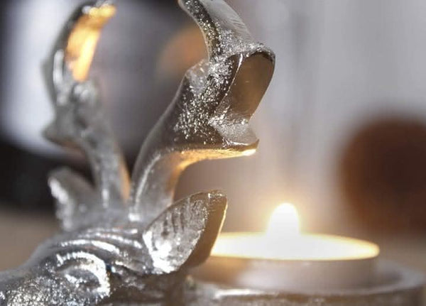 Reindeer tea light holder displayed on mantelpiece