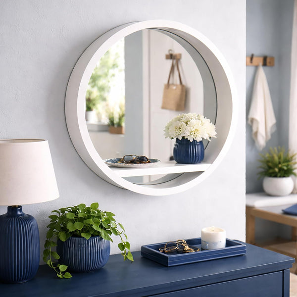 Round wall mirror positioned above a dressing area
