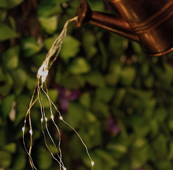 Illuminated garden ornament creating the illusion of falling water