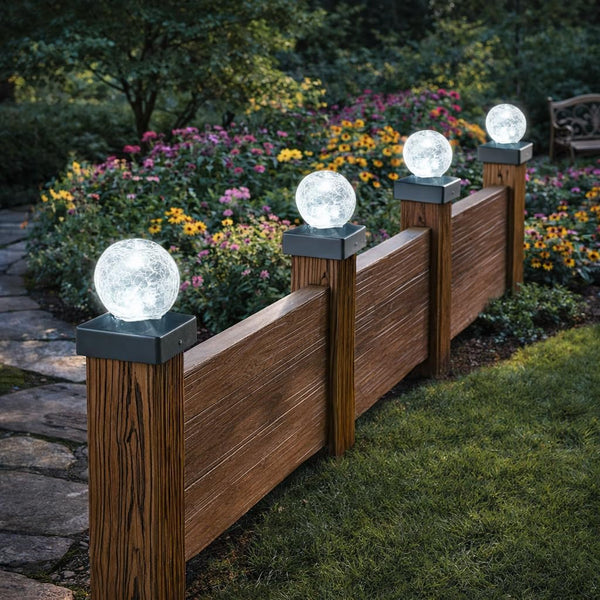 Solar-powered crackle ball lights on fence posts
