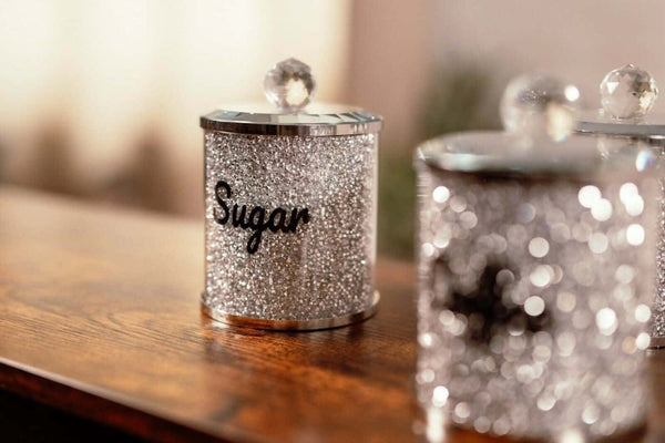 Three crystal storage jars displayed on a kitchen worktop