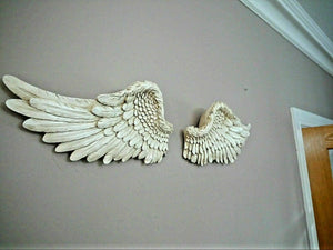 Detailed silver feather wall sculpture in a vintage interior