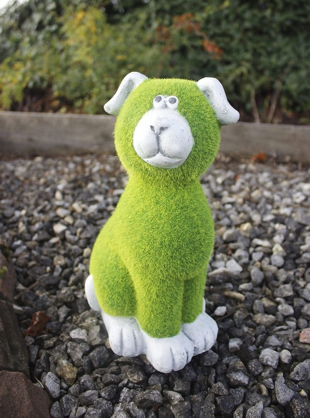 Stone and grass effect dog garden ornament on lawn