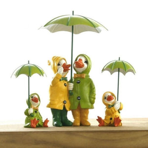 Duck family garden ornaments wearing colourful raincoats