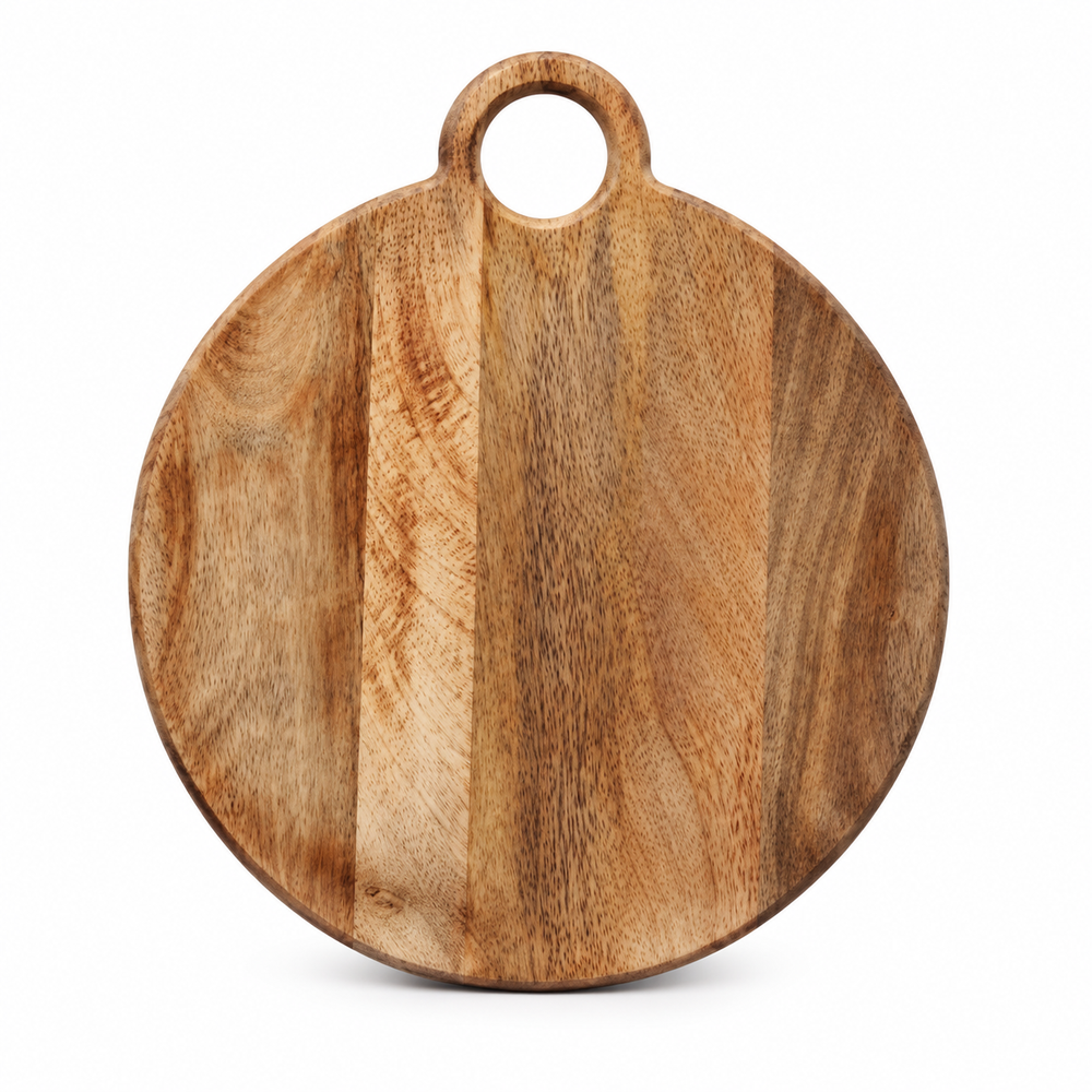 Round wooden cutting board with a handle, styled on a light beige countertop with a red bell pepper, sliced cucumbers, a cherry tomato, a chef's knife, and fresh basil.