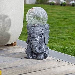 Decorative elephant light holding a colour changing crackle globe