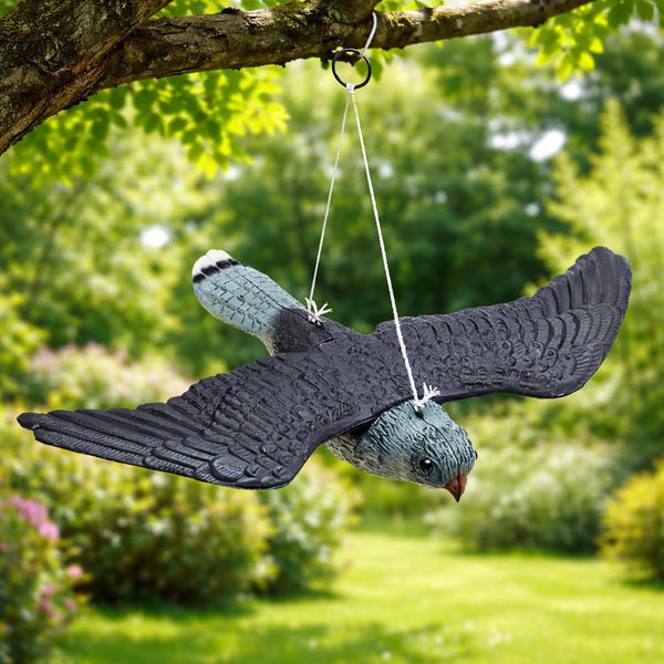 Plastic falcon bird repeller suspended from a tree