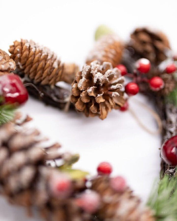 Faux fir wreath accented with festive red berries