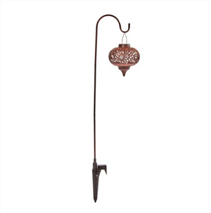 Moroccan style lanterns suspended from metal garden stakes
