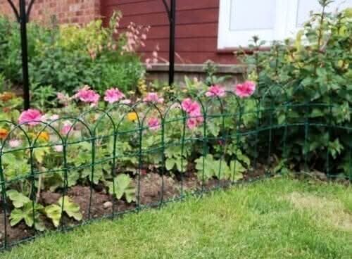 Green garden fencing used along lawn edge