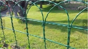 Green wire lawn edging shown installed outdoors