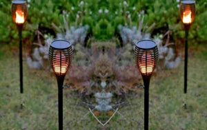 Flickering flame stake light displayed in garden