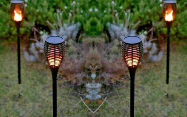 Flickering flame stake light displayed in garden