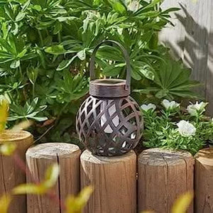 Solar flame lantern displayed in an outdoor garden