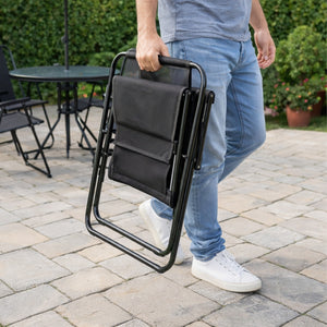 Black table and chair set arranged for a barbecue