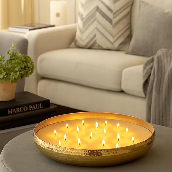 Decorative bowl with multiple small candles on a table in a living room setting.