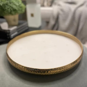 Round woven basket with white interior on a dark surface