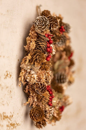 Small scented Christmas wreath hanging from a door