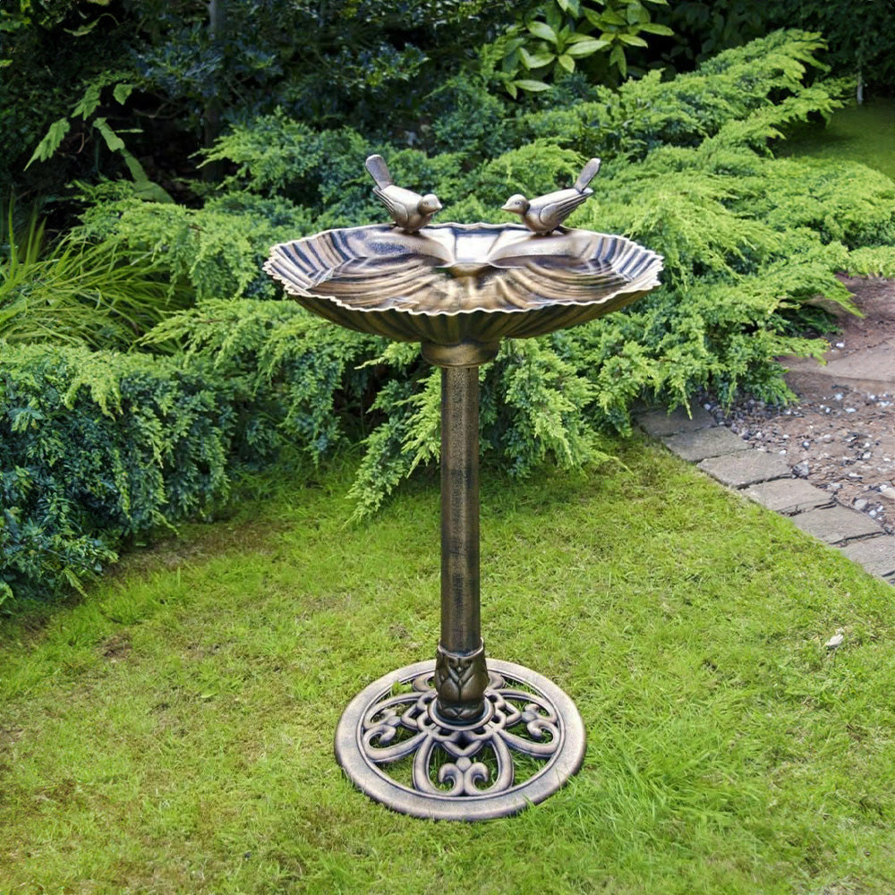 Bronze effect freestanding bird bath in garden setting
