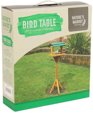 Freestanding traditional bird table for outdoor garden display