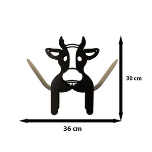 Metal cow holder storing spare toilet rolls