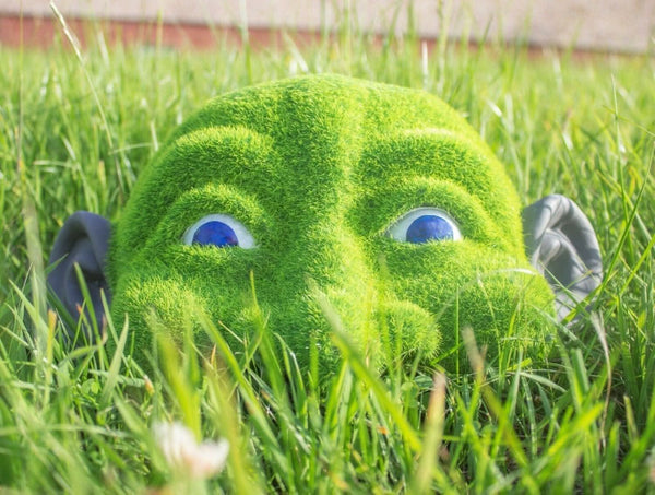 Resin garden sculpture with green grass effect
