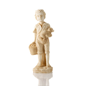 Boy and girl statues displayed together on a patio