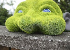 Novelty head sculpture displayed in garden